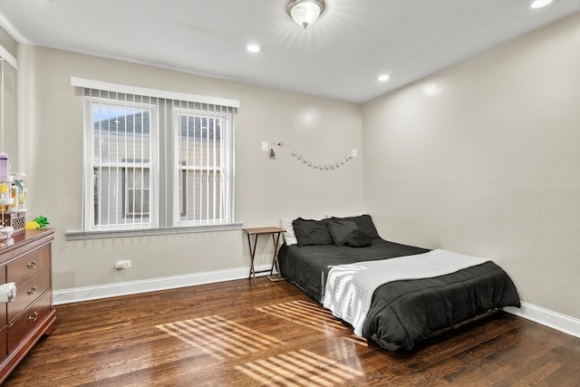 bedroom with recessed lighting, wood finished floors, and baseboards