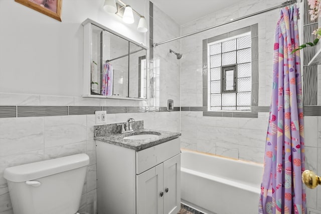 bathroom featuring shower / tub combo with curtain, tile walls, vanity, and toilet