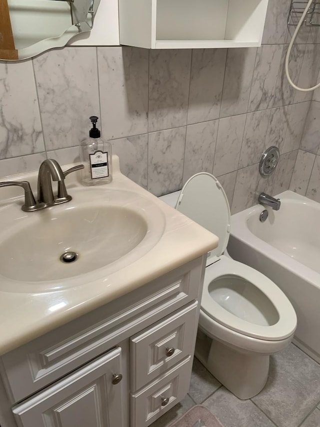 bathroom featuring decorative backsplash, toilet, tub / shower combination, vanity, and tile walls