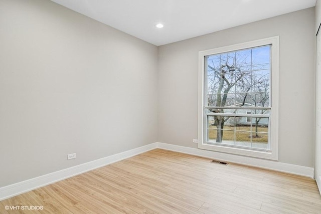 unfurnished room featuring recessed lighting, visible vents, light wood-style flooring, and baseboards