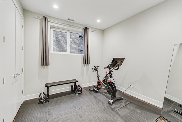 exercise room with recessed lighting and baseboards