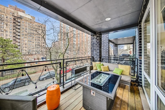 balcony featuring an outdoor living space with a fire pit