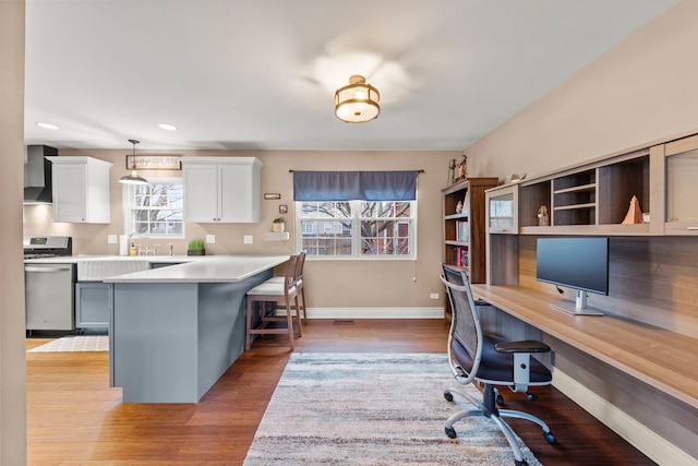 office area featuring recessed lighting, baseboards, and light wood finished floors