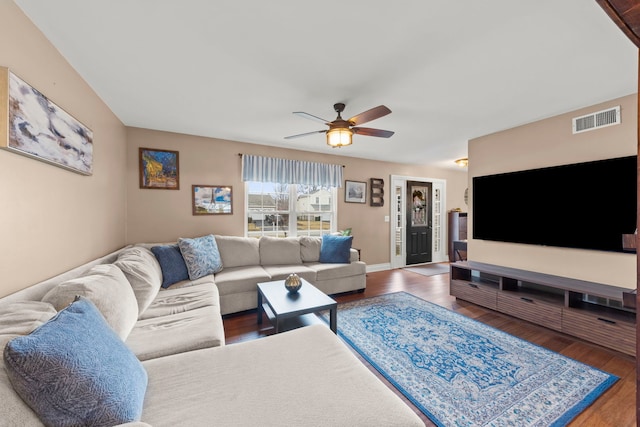 living area featuring ceiling fan, wood finished floors, visible vents, and baseboards