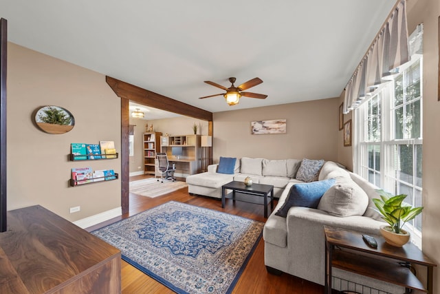 living room with dark wood-style floors, ceiling fan, and baseboards