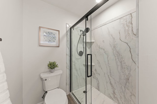 full bathroom with a marble finish shower and toilet