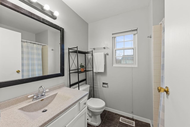 bathroom featuring tile patterned flooring, toilet, vanity, visible vents, and baseboards