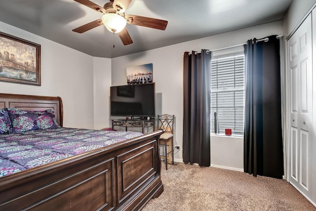 bedroom with baseboards, ceiling fan, a closet, and light colored carpet