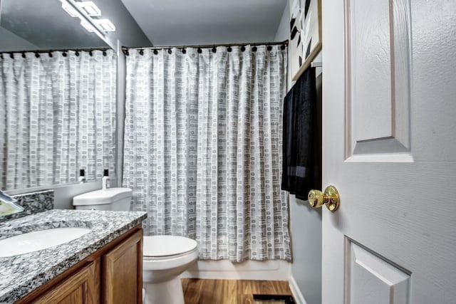 bathroom featuring vanity, a shower with shower curtain, wood finished floors, and toilet