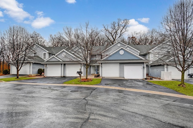 view of front of house with aphalt driveway and an attached garage