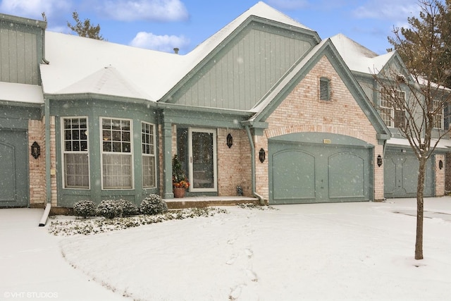 view of front of house featuring a garage and brick siding