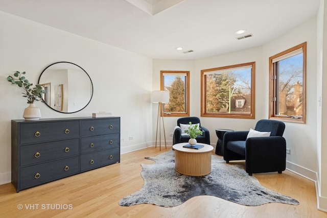 living area featuring recessed lighting, visible vents, baseboards, and light wood finished floors