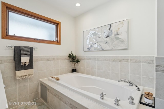 bathroom featuring recessed lighting and a bath