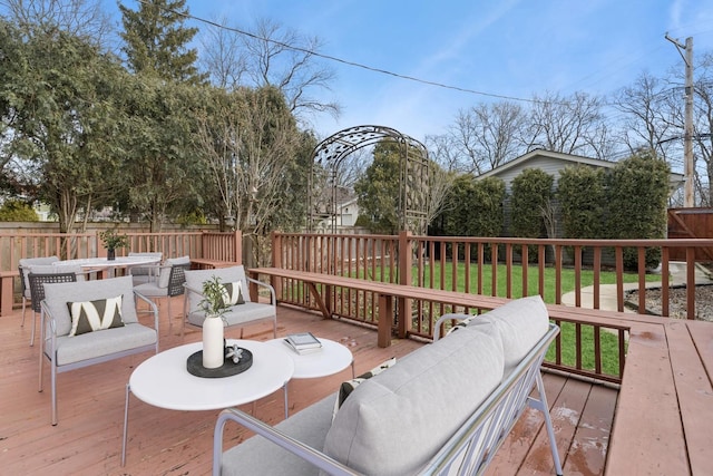 deck featuring a lawn, outdoor lounge area, outdoor dining area, and a fenced backyard