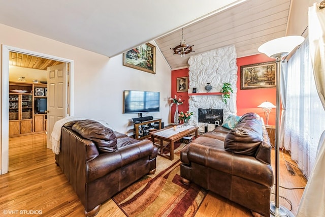 living room featuring wooden ceiling, a fireplace, vaulted ceiling, and wood finished floors