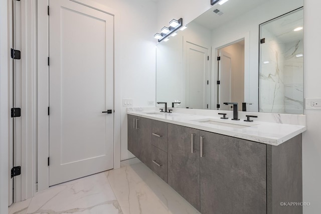 bathroom with double vanity, a marble finish shower, visible vents, marble finish floor, and a sink