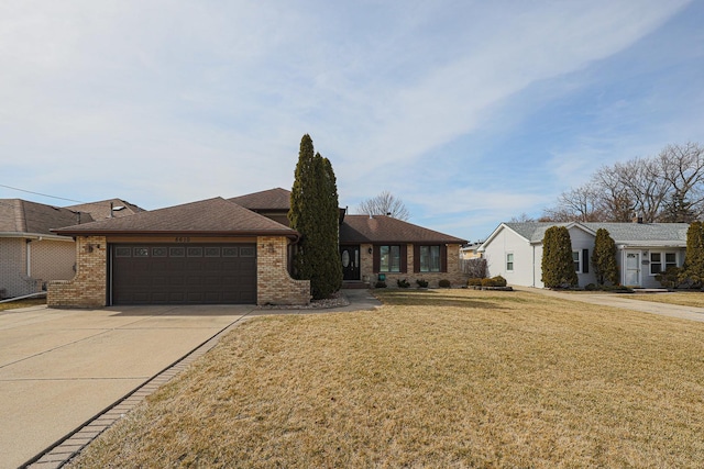 view of front of home featuring a front lawn, an attached garage, brick siding, and concrete driveway