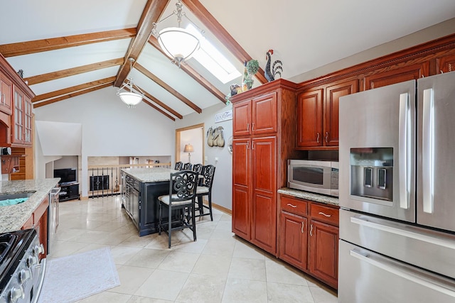 kitchen featuring light stone counters, lofted ceiling with beams, light tile patterned flooring, a sink, and appliances with stainless steel finishes