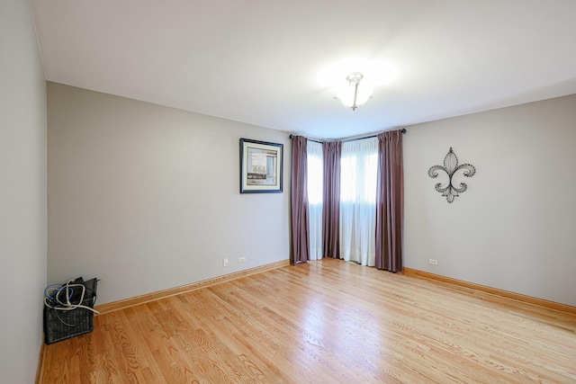 empty room with wood finished floors and baseboards