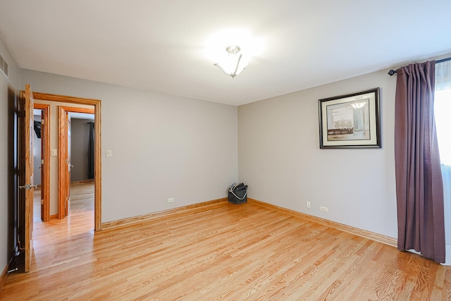 unfurnished room featuring light wood-type flooring and baseboards