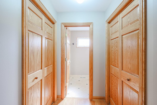 hallway with light wood-style floors