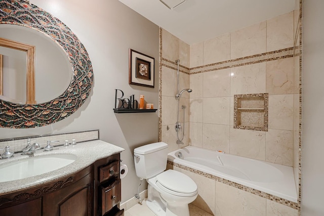 full bathroom featuring tiled shower / bath combo, toilet, and vanity