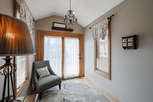 sitting room with an inviting chandelier, lofted ceiling, light tile patterned flooring, and a healthy amount of sunlight