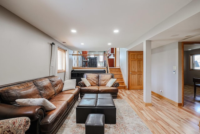 living room featuring recessed lighting, stairway, light wood-style flooring, and baseboards