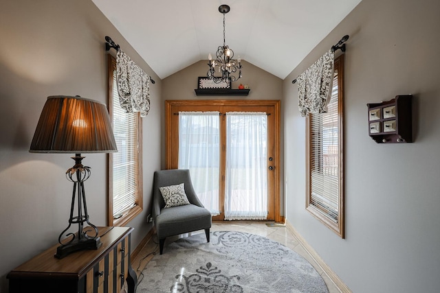 living area with an inviting chandelier, lofted ceiling, light tile patterned flooring, and baseboards