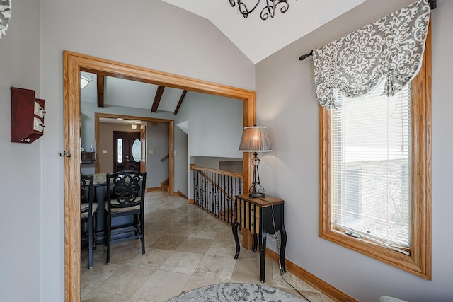 hall with vaulted ceiling, an upstairs landing, and baseboards