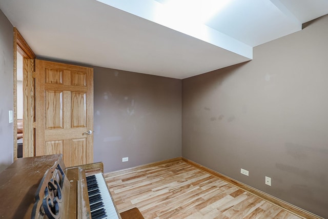 interior space with baseboards and light wood finished floors