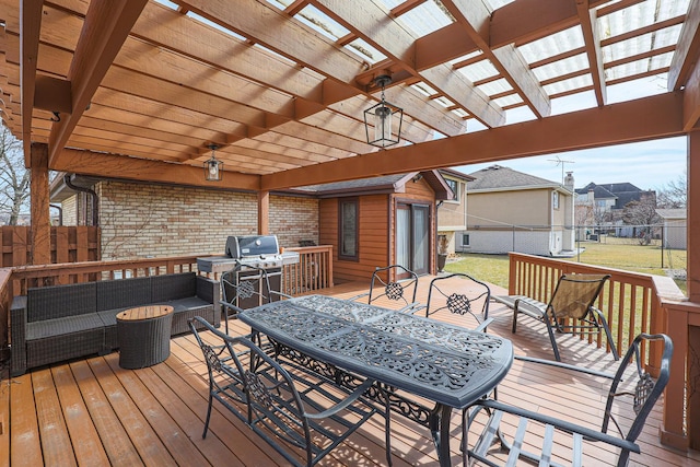 wooden terrace with outdoor dining space, fence, a yard, a pergola, and an outdoor hangout area