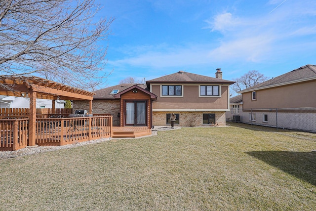 rear view of house featuring a pergola, fence, brick siding, and a lawn