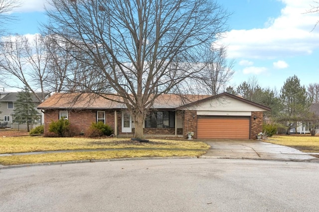 ranch-style house featuring a front yard, brick siding, driveway, and an attached garage