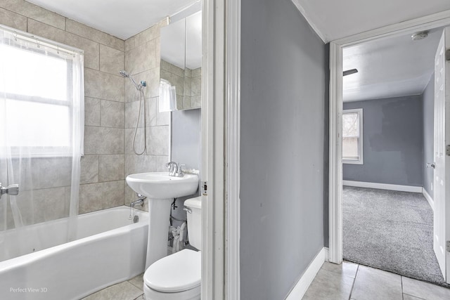 full bath with baseboards, shower / bath combination, toilet, and tile patterned floors