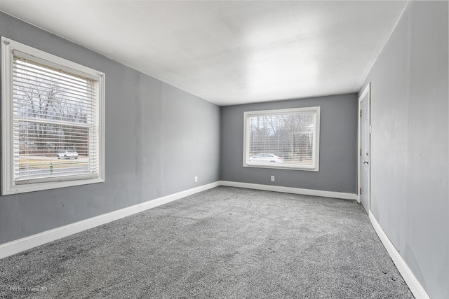 carpeted spare room with baseboards