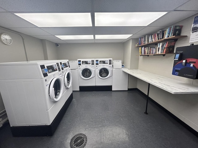 shared laundry area featuring dark floors and washer and dryer