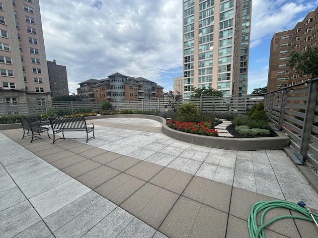 surrounding community featuring a patio and a city view