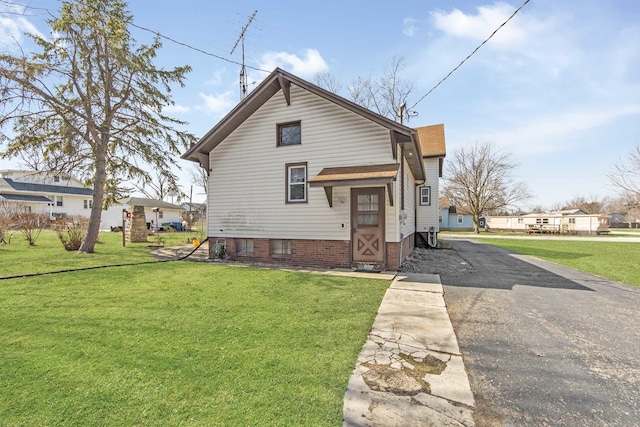 619 Lincoln St, Minonk, IL 61760 - rear view of property featuring aphalt driveway and a yard