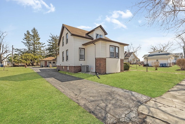 619 Lincoln St, Minonk, IL 61760 - view of home's exterior featuring central air condition unit, a lawn, and driveway