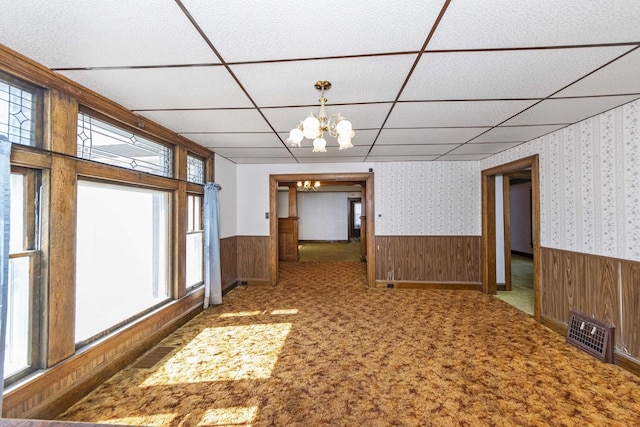 619 Lincoln St, Minonk, IL 61760 - empty room featuring a wealth of natural light, a wainscoted wall, visible vents, a notable chandelier, and wallpapered walls