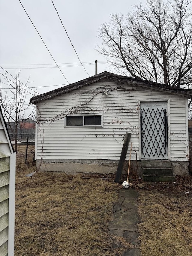 view of side of property featuring entry steps and fence