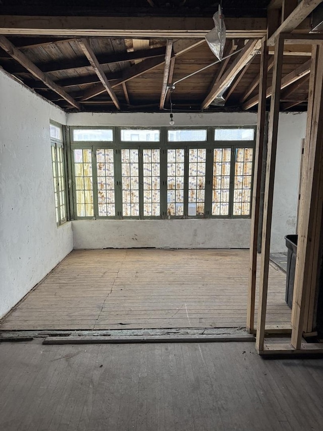 miscellaneous room featuring wood-type flooring and a textured wall