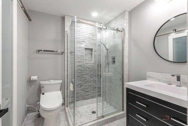 bathroom featuring toilet, vanity, baseboards, marble finish floor, and a shower stall