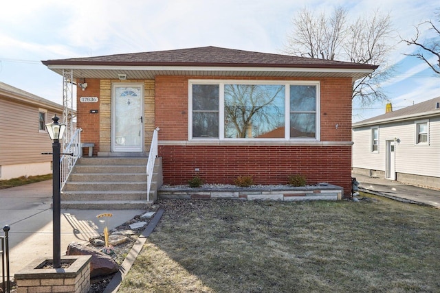 bungalow-style house featuring brick siding