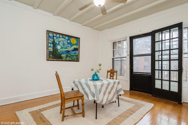 dining space featuring beam ceiling, baseboards, ceiling fan, and hardwood / wood-style floors