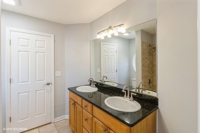 full bath featuring double vanity, a sink, and tile patterned floors