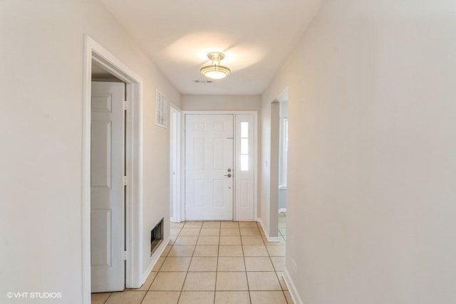 entryway featuring light tile patterned floors, baseboards, and visible vents