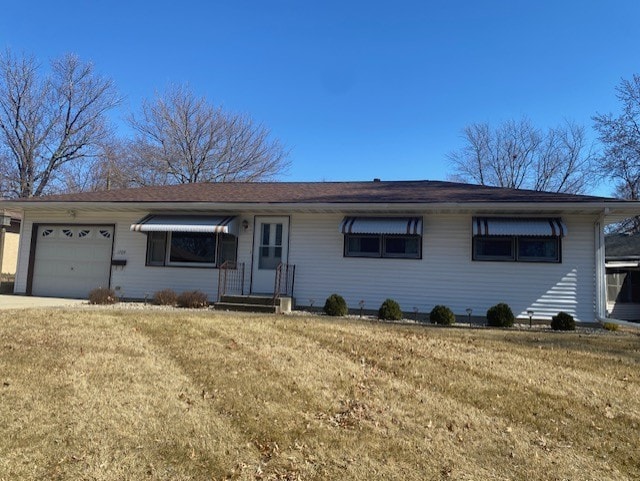 single story home with a front yard and an attached garage