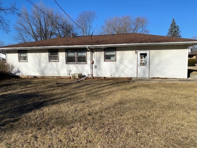 back of house featuring a yard and central air condition unit